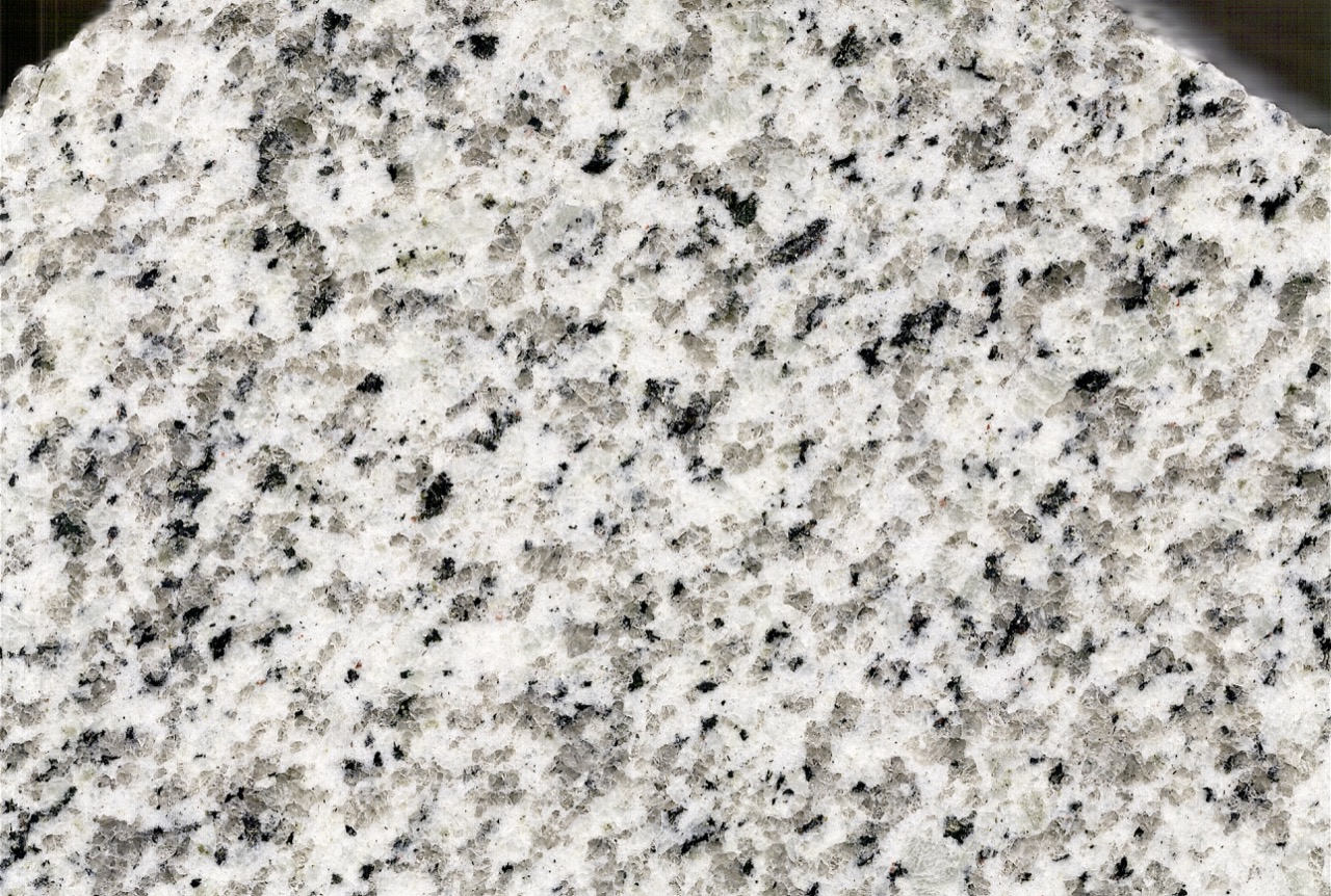 Close-up of polished granite showing a speckled pattern of grey, white and black mineral grains.