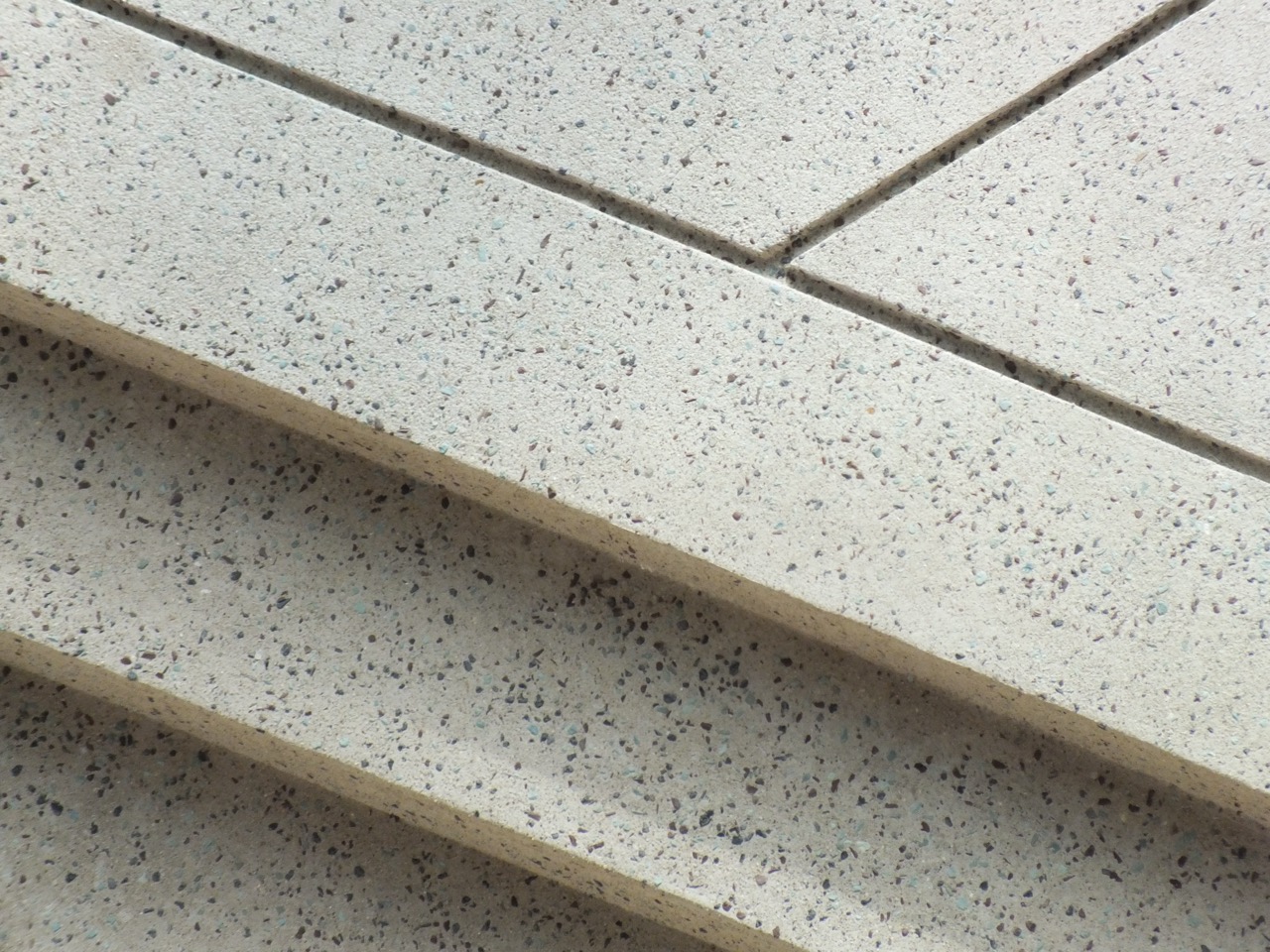 Close-up of polished marble flooring showing pale stone with dark grey veining.